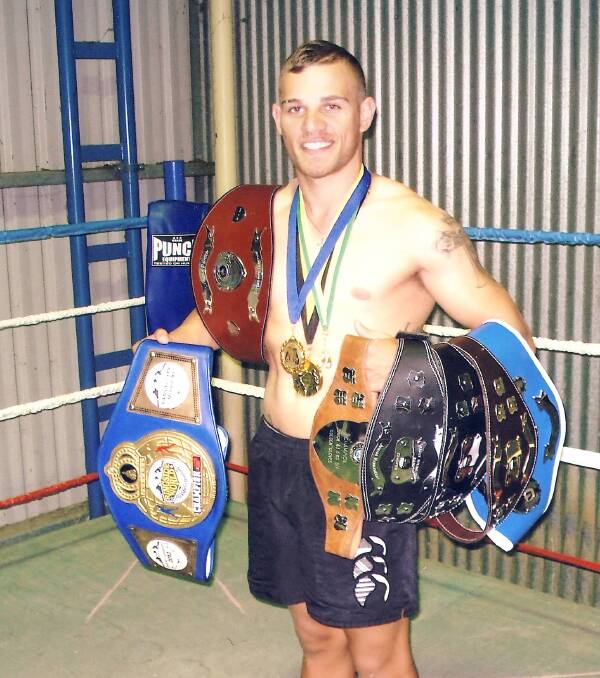 Lynken Dickson with his NSW Welterweight belt and array of championship belts which the local boxer and his trainer are planning on adding to. 
