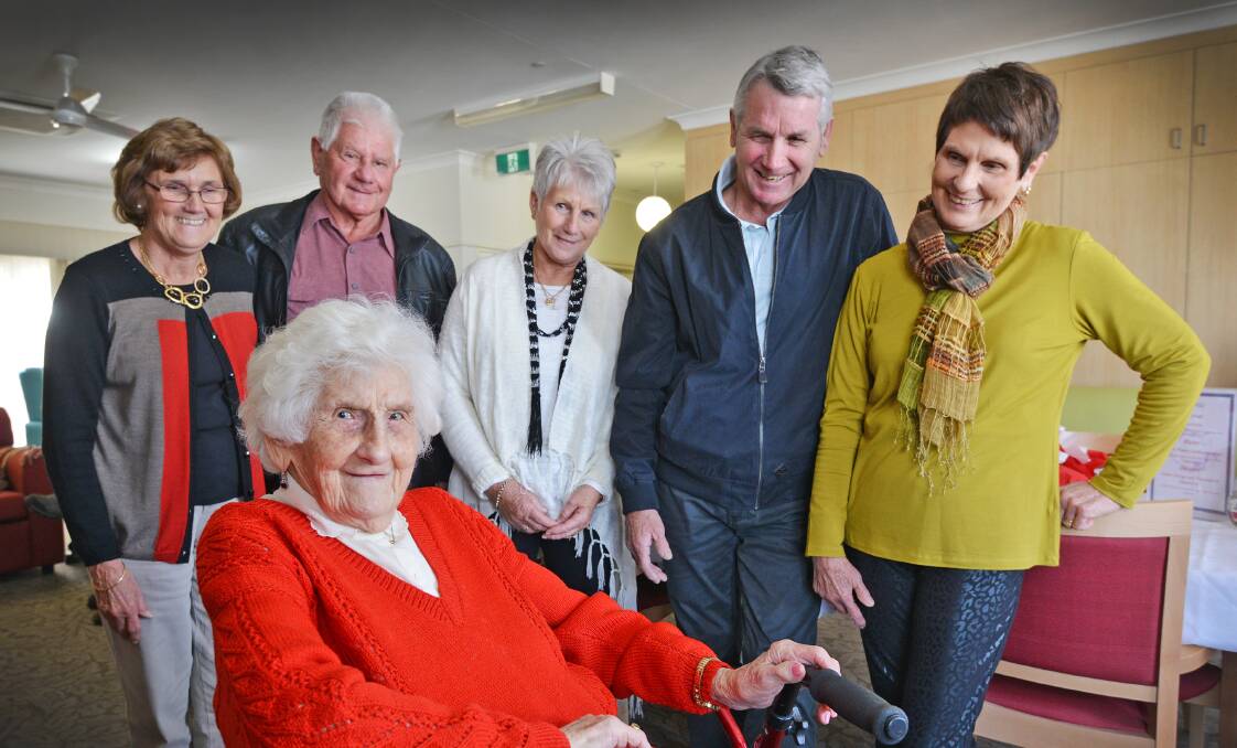 BRIGHT AS A BUTTON: Nell Johnston, 101, surrounded by her five children, from left, Jeanette Moroney, Michael Johnston, Fay Williams, Brian Johnston and Maureen Johnston. Photo: Barry Smith 050815BSD02