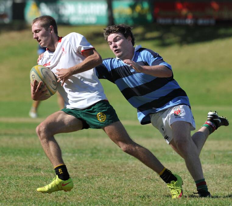 New England’s Tom Fischer makes a last-ditch effort to stop Central North’s Matt McRae during Sunday’s U20s trial.  Photo: Paul Matthews Photographics