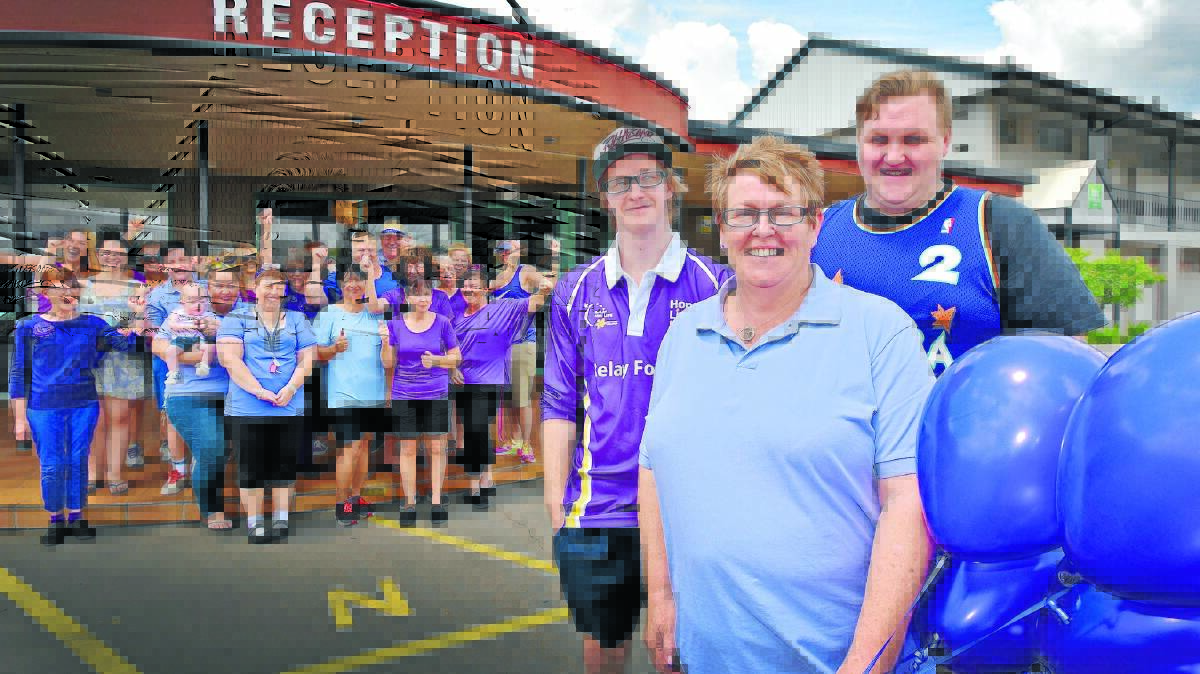 STRIKING AWARENESS: Harry, Karen and Mitch Webster and staff of Ibis Styles went purple to raise awareness of pancreatic cancer. Photo: Geoff O'Neill 131115GOC01