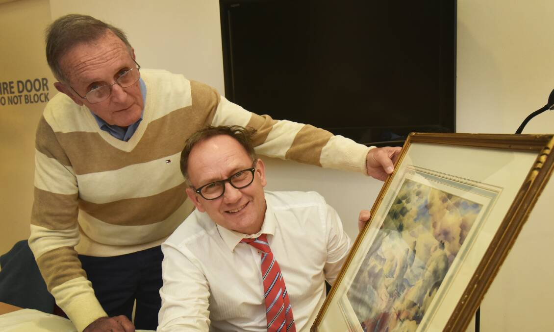 SURPRISE FIND: John Vickery with valuer Henry Mulholland and his 1947 watercolour. Photo: Geoff O’Neill 190615GOC01