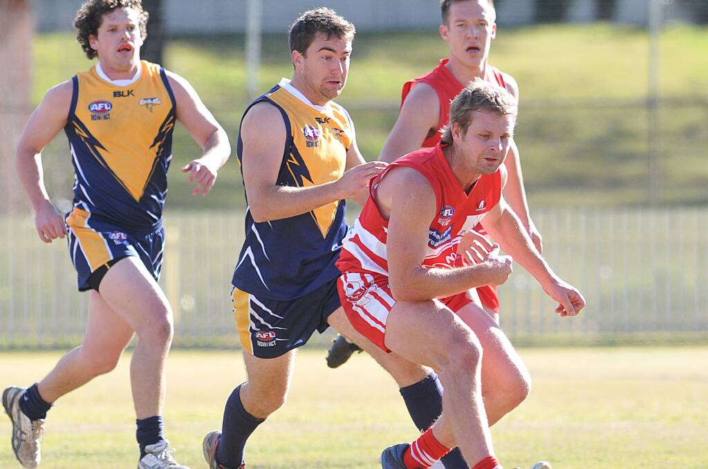 Lachlan Rowling returned to the club in 2014 and tied for third in their B&F. Here he leads the chase to the loose ball against the Narrabri Eagles.  Photo: Geoff O’Neill 120714GOF02