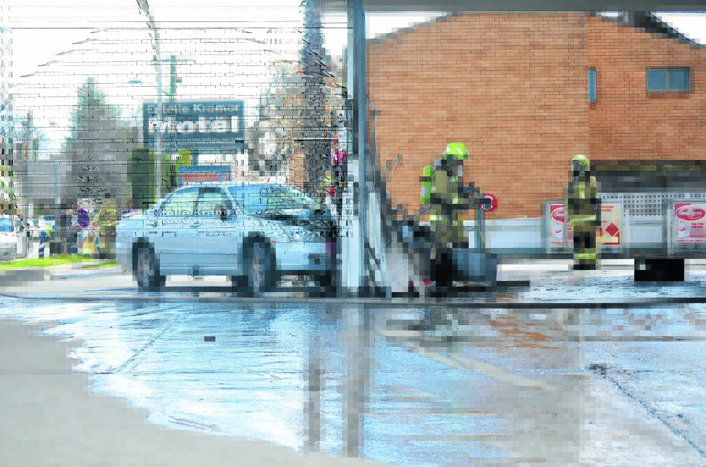 LUCKY ESCAPE: A male driver is believed to have lost control of a car before crashing into a petrol bowser in Armidale. Photo: Dannielle Maguire, Armidale Express
