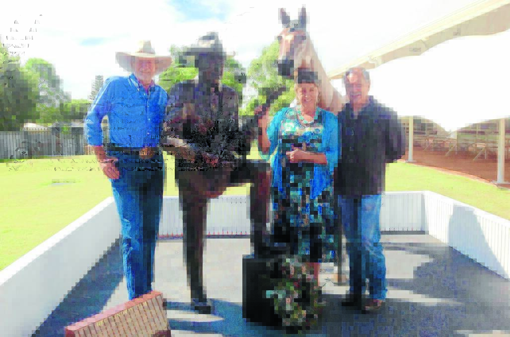 HAPPY DAY: Bruce McCumstie, Ros Lindsay and MC Jon Wolfe with the Standing Tall statue.