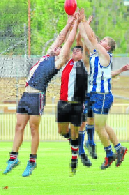 Inverell Saints pair (from left) Anthony Pages and Troy Dan battle with Tamworth Kangaroo Todd Brazel for this mark in Saturday's TAFL victory for the visitors. Photo: Geoff O'Neill 090416GOB03