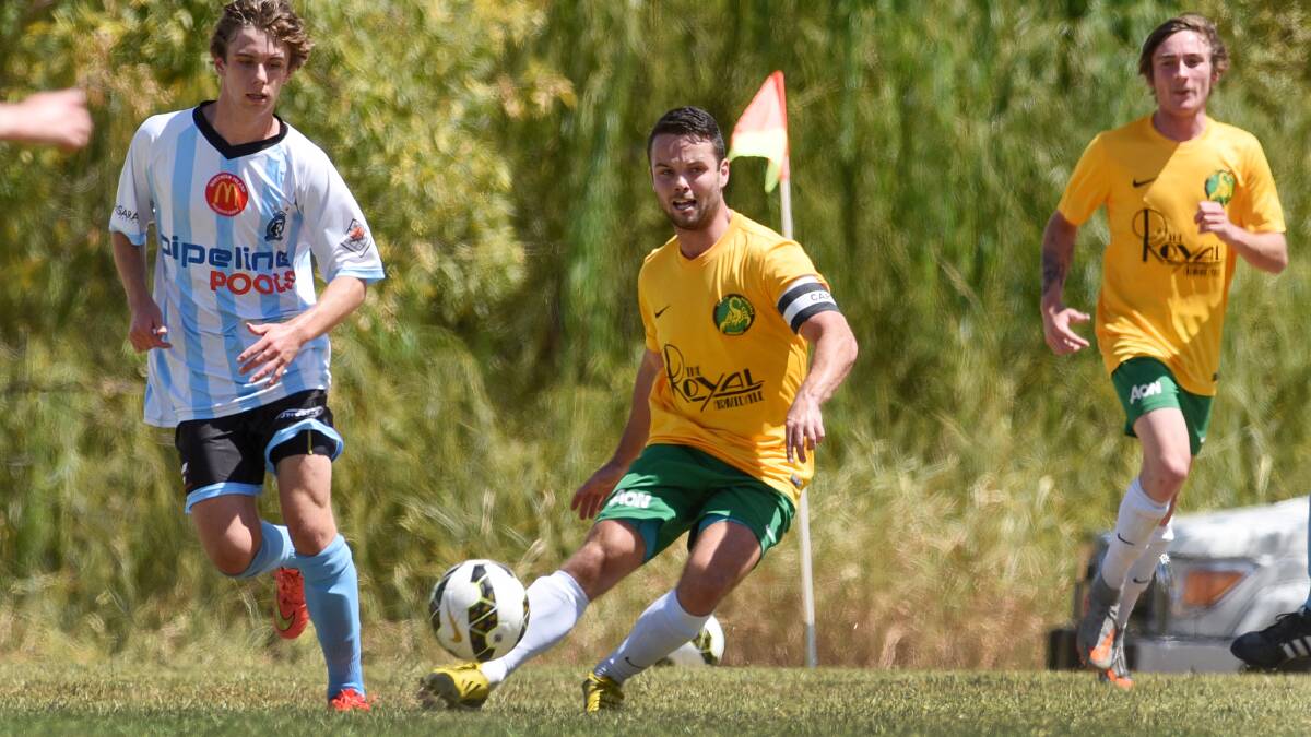 South Armidale captain-coach Ben Wright looks to spark an attacking move as Tamworth FC’s Jake Thompson gives chase. Photo: Gareth Gardner 280216GGB07