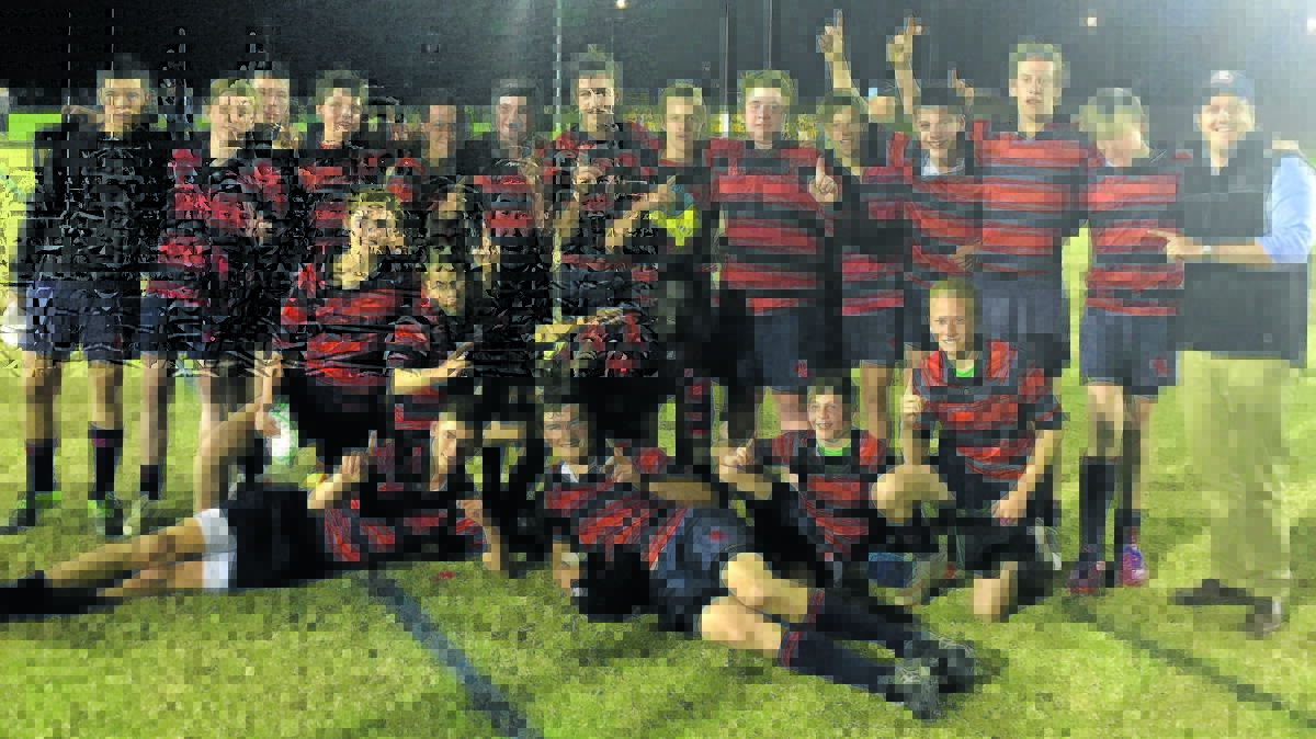 The victorious Calrossy Anglican School Under 15s rugby team with coach Barton Leach.