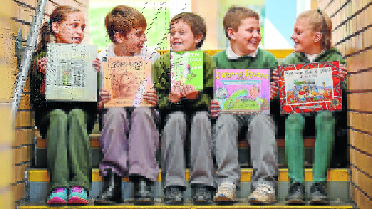 BOOK WORMS: Years 3 students Paris Creighton, left, Olly Maguire, Izac Black, Lochie Nixon and Simone Greatbatch have contributed to a big improvement in Hillvue Public’s NAPLAN reading results this year. Photo: Gareth Gardner 010915GGC03
