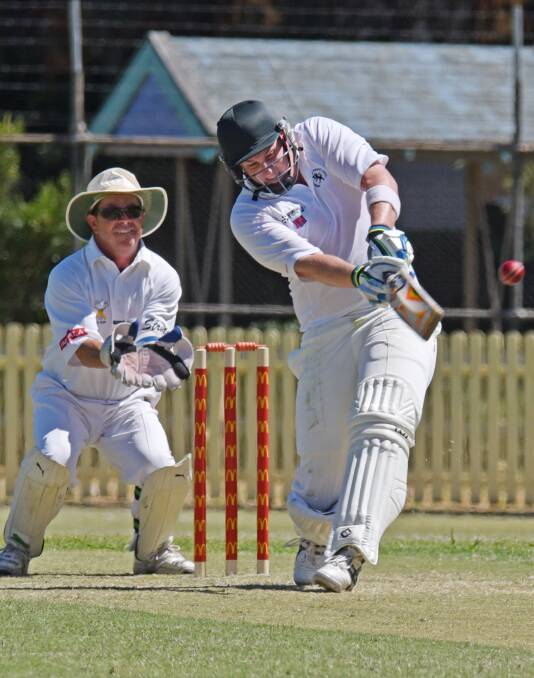 Armidale wicketkeeper Brad Smith hits out on his way to 49 in Sunday’s War Vets Cup semi-final loss to Tamworth. Tamworth keeper is Bective-East’s James Haling.  Photos: Geoff O’Neill 070216GOC03