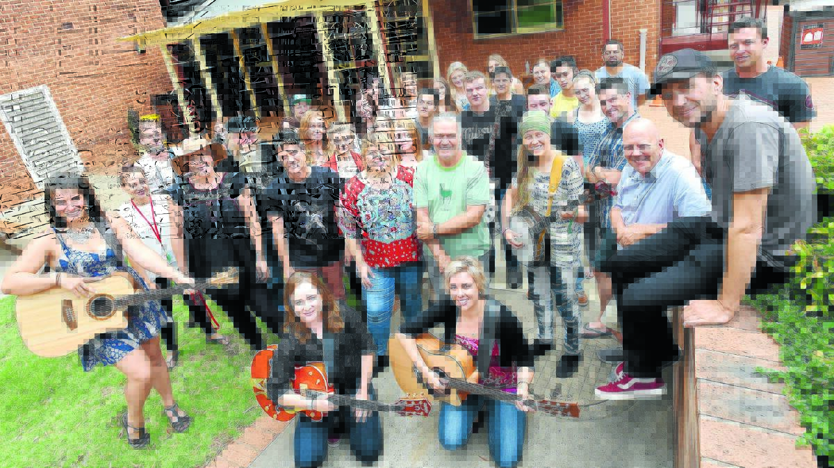 CLASS OF 2016: CMAA Academy of Country Music students including  Sarah Leete, Josie Laver and Emma Dykes with their guitars and Chloe Nott with her banjo in front, with tutors (behind) Catherine Britt (with her hat on), Simon Johnson, director Lyn Bowtell, Kevin Bennett, general manager Roger Corbett and Karl Broadie (sitting on wall). Photo: Gareth Gardner 040116GGC01