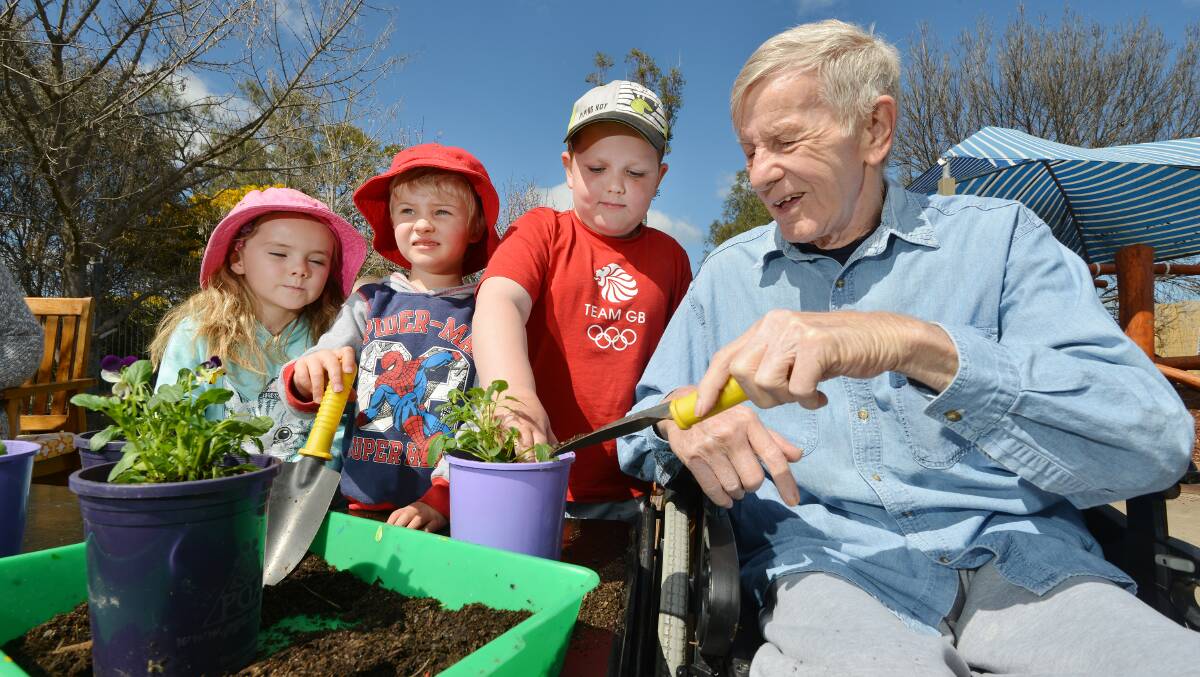GREEN THUMBS: Quirindi preschoolers Layla Gilchrist, Oliver Frith and Jack Bennett get potting with Eloura resident Mil Pospisil. Photos: Barry Smith 090915BSD02