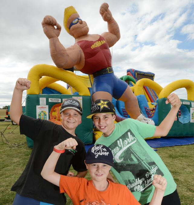 WHAT A CRACKER: Travis Fitzsimmons, 10, (front), Justin Roberts, 11, (left) and Joel McIntyre, 11, (right) get into the spirit of Calrossy’s inaugural cracker carnival fundraising event on Saturday. Photo: Barry Smith 210315BSD03