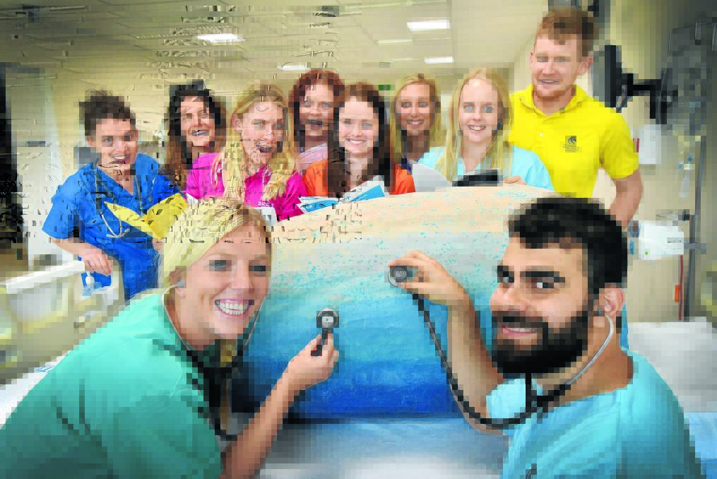CRACK-UP TIME: Newcastle University trainee doctors, at front, Sally Sinclair and Daniel Zardawi, with their colleagues, at back, Ellen Sweeney, Elly McCarroll, Nina Axelsen, Elizabeth Brown, Hannah Wells, Ellie Fowler, Gabi Bailey and James Morris. Photo: Geoff O’Neill 290915GOB01