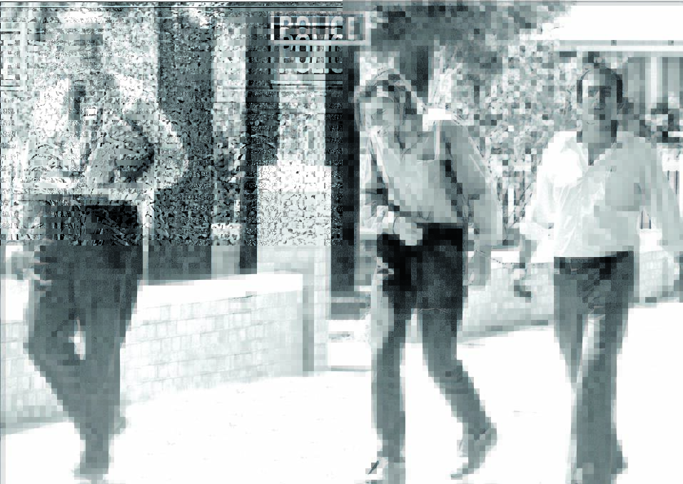 THEN: Kevin Crump, centre, is led handcuffed into the Narrabri Court House after his arrest in 1973.