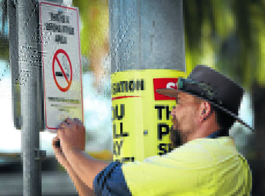 BUTT OUT: No-smoking signs were erected in the city’s CBD by council staff yesterday. Photo: Geoff O’Neill 140116GOB02