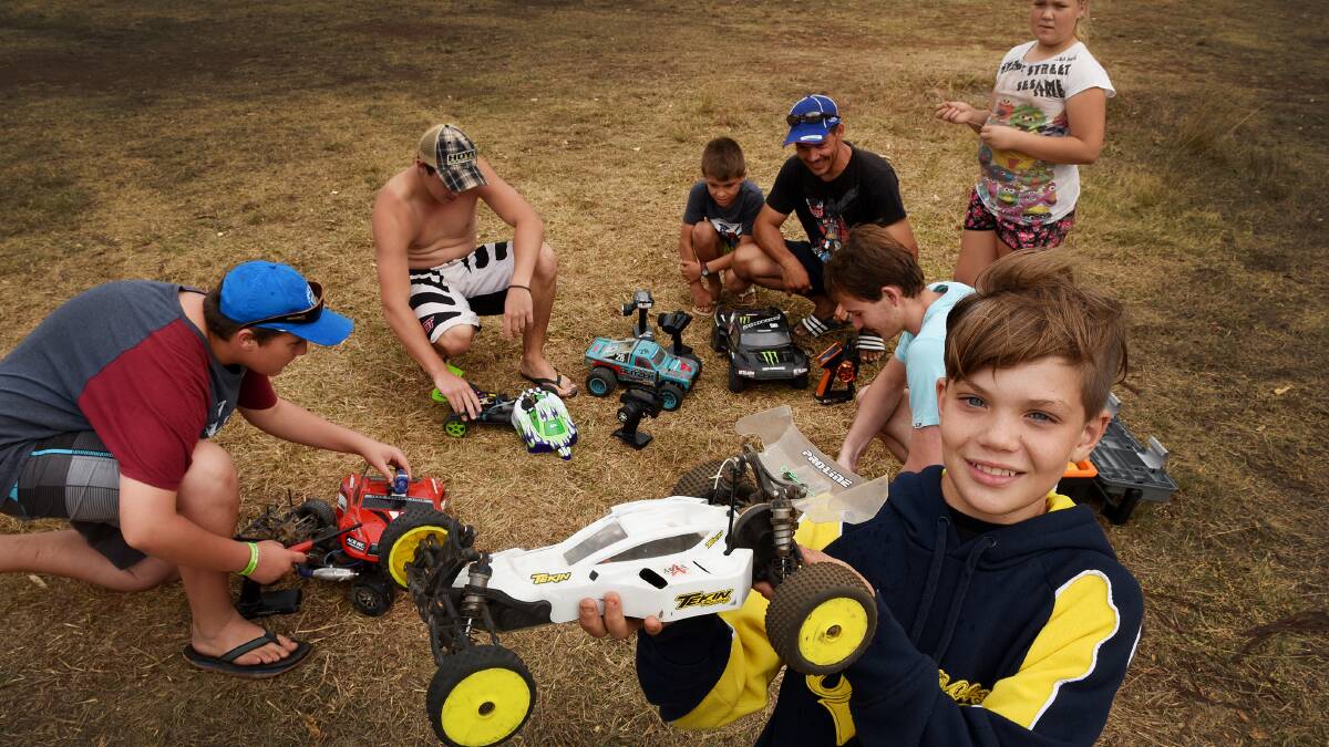 IN CONTROL: Hamish Wilson with his remote-controlled car and fellow enthusiasts having some fun at Chaffey Dam. Photos: Gareth Gardner 030415GGD07