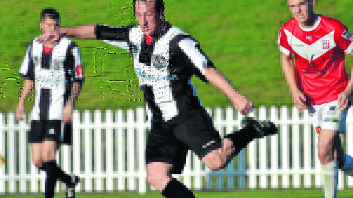 Ben Davis on the attack for North Companions in last season's NIFPL first grade final against OVA. He was to have coached the Men In Black but has decided to return to Tamworth FC. Photo: Geoff O'Neill 130915GOH10