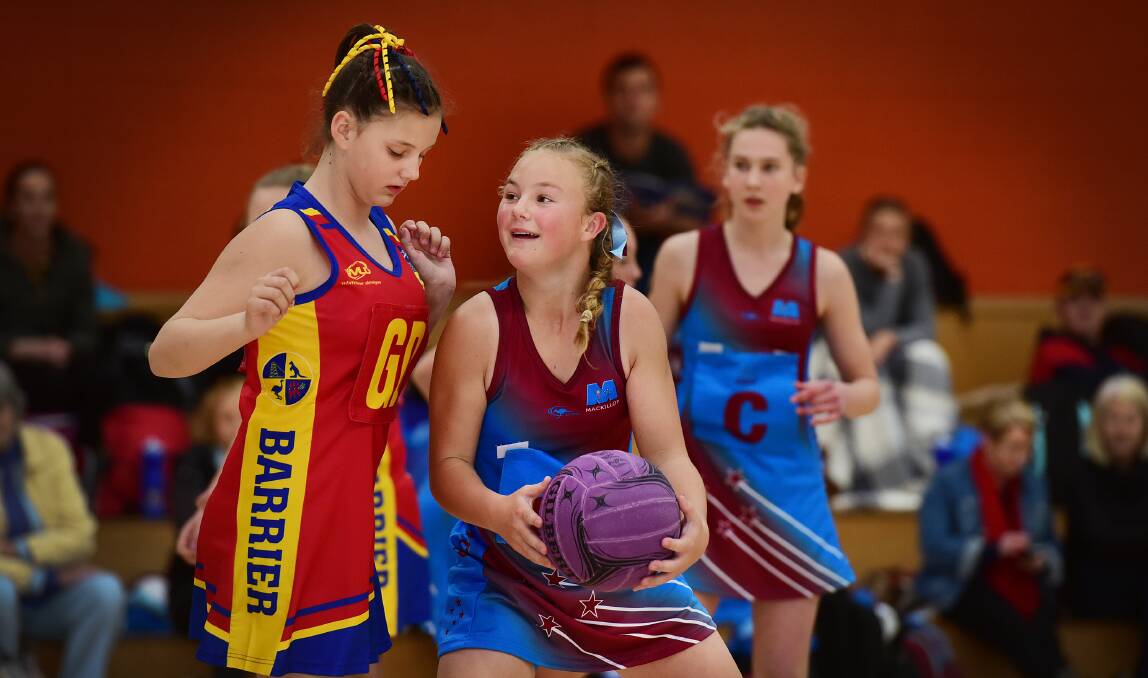 MacKillop’s Lucy McIntyre (right) plays with a laugh as Barrier’s Hayley Beck ensures there is no contact.  210715GGF01