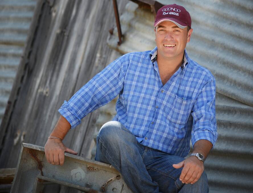 FIRST-CLASS DEBUT: Ryan Morris takes a break from working on the Nemingha red angus stud, Goonoo, to celebrate his top-selling iTunes position on the charts. Photo: Barry Smith 110116BSA04