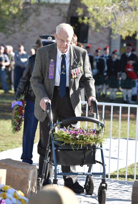 HOMETOWN RETURN: World War II veteran Jack Beaven prepares to lay a floral tribute for the mates he lost and all who served in WWII. Photo: Geoff O’Neill 250415GOC45