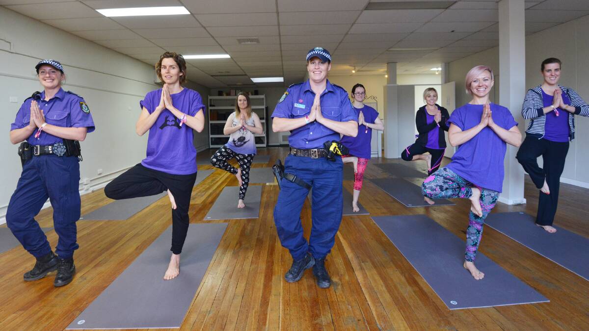 POLICE POSE: Front, Constable Maria Nolan, Amber Pike, Senior Constable Naomi Welch and instructor Charlie Abra; back, Jessica Miller, Elizabeth Barnes, Vanessa Campbell and Eden Martin take part in a yoga session for Wear It Purple Day yesterday at the Tathra & Yoga Healing. Photo: Barry Smith 280815BSD01