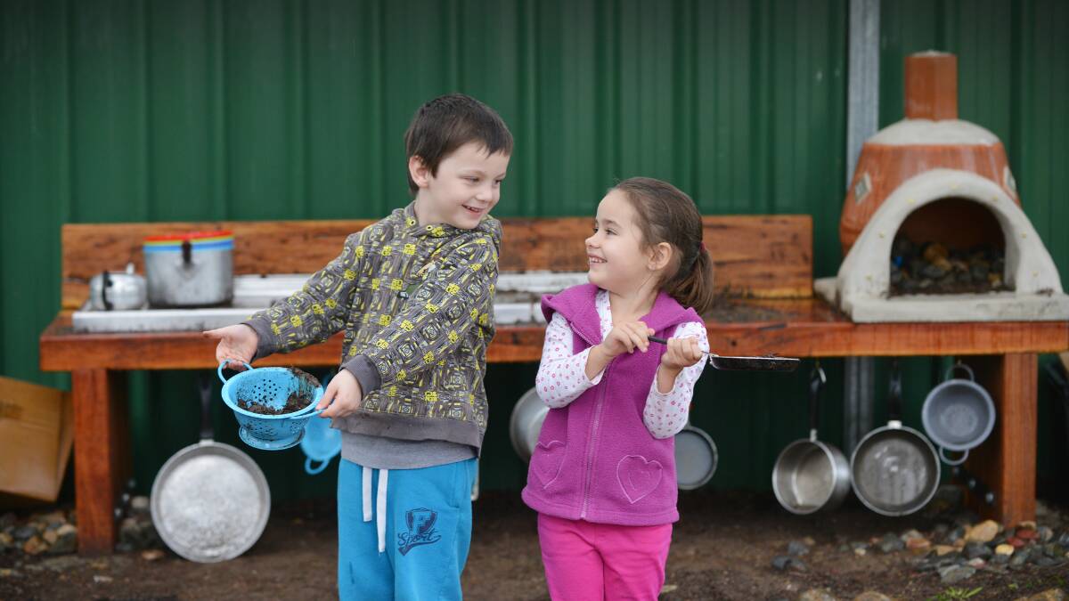 MINI MUDDERS: Manilla preschoolers Isaac Brown, 5, and Belle Scanlon, 4, cook up some pies in their mud kitchen. Photo: Barry Smith 170615BSC05