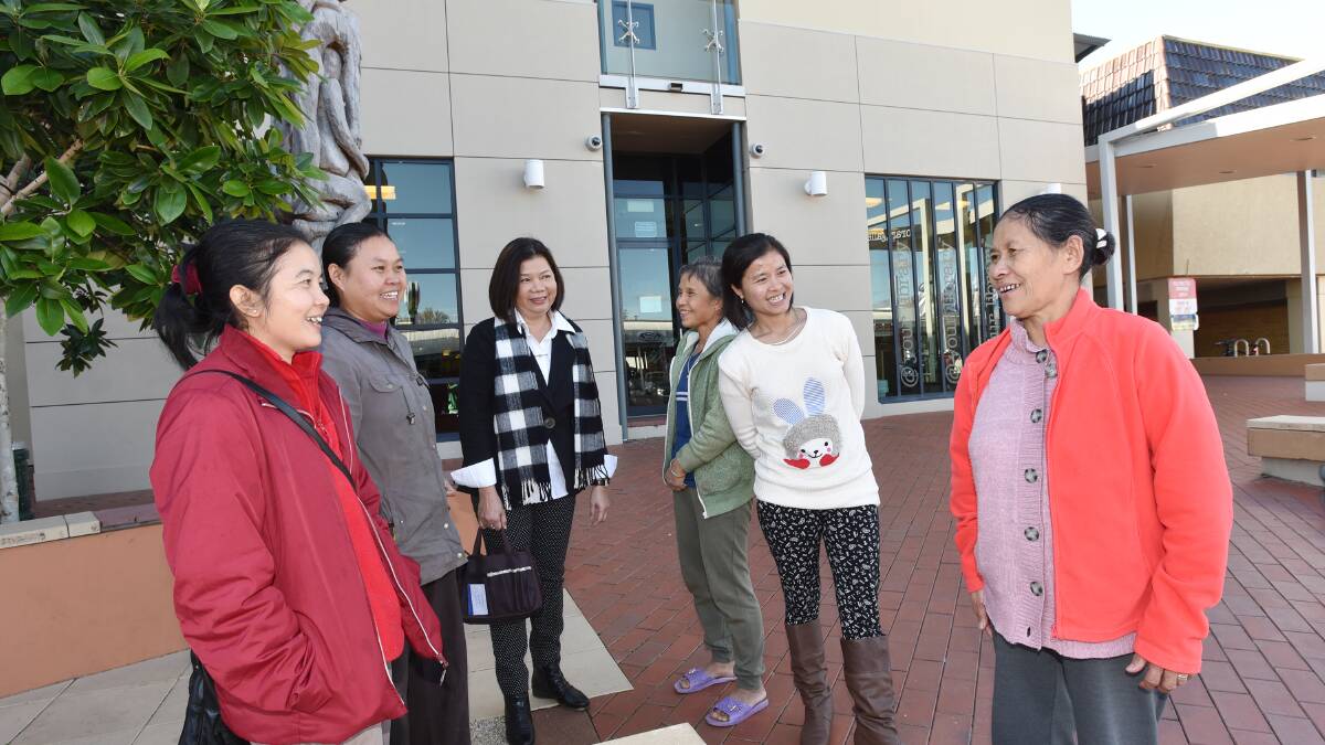 MUCH TO CELEBRATE: Amalin Sundaravej, third from left, with Burmese refugees Christa Beil, May Way Htoo, Ra Lu, Candy Christy and Bu Re in the Tamworth library forecourt where Refugee Week celebrations will be held tomorrow. Photo: Geoff O’Neill 110615GOC01