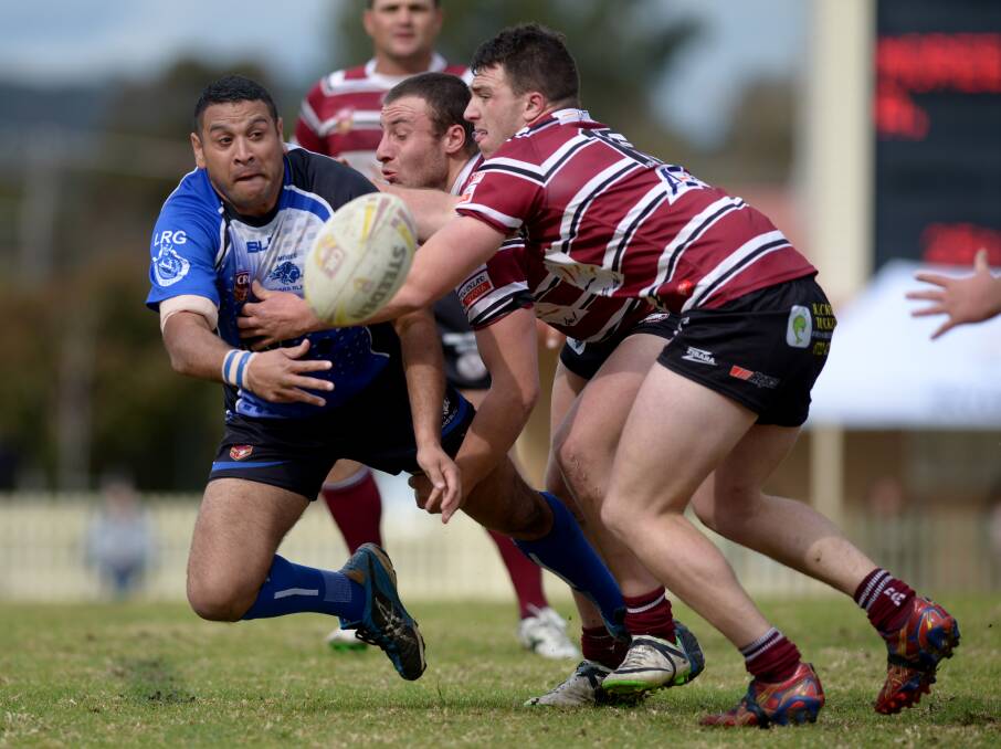 Moree’s Marshall Barker gets an offload away in the tackle of Inverell’s  Luke and Jake Deaves. Photo: Grant Robertson.