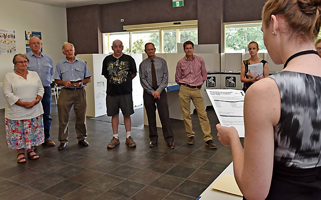 ANTICIPATION: Tamworth electorate returning officer Sarah Risby conducts the ballot draw, watched by candidates Pat Schultz, far left, Peter Draper, second from left, Joe Hillard, third from right, and Kevin Anderson, second from right. Photo: Geoff O’Neill 120315GOA02