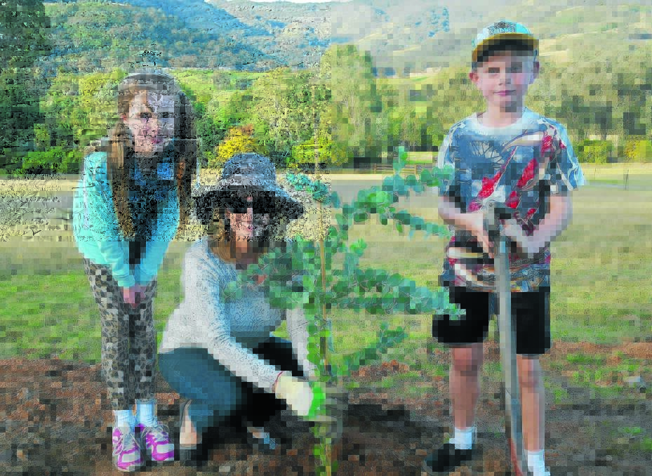LEFT – IN MEMORY: Glen Turner’s wife, Alison, and children Alexandra and Jack are urging locals to plant a tree this week to remember the Office of Environment and Heritage officer, who was killed in the line of duty one year ago today. Photo: Supplied