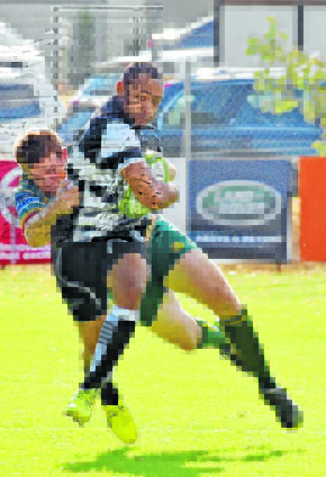 Inverell winger Simon Clarke drives Tamworth centre Wes Rooney into touch to foil a break. Photo: Geoff O’Neill 230416GOD04