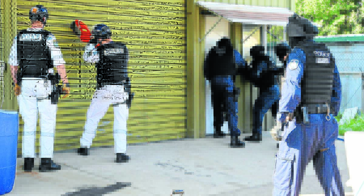 SHUT DOWN: Tamworth police, backed by officers from Strike Force Raptor, raid the Rebels’ headquarters in Tamworth in March. Photo: NSW Police
