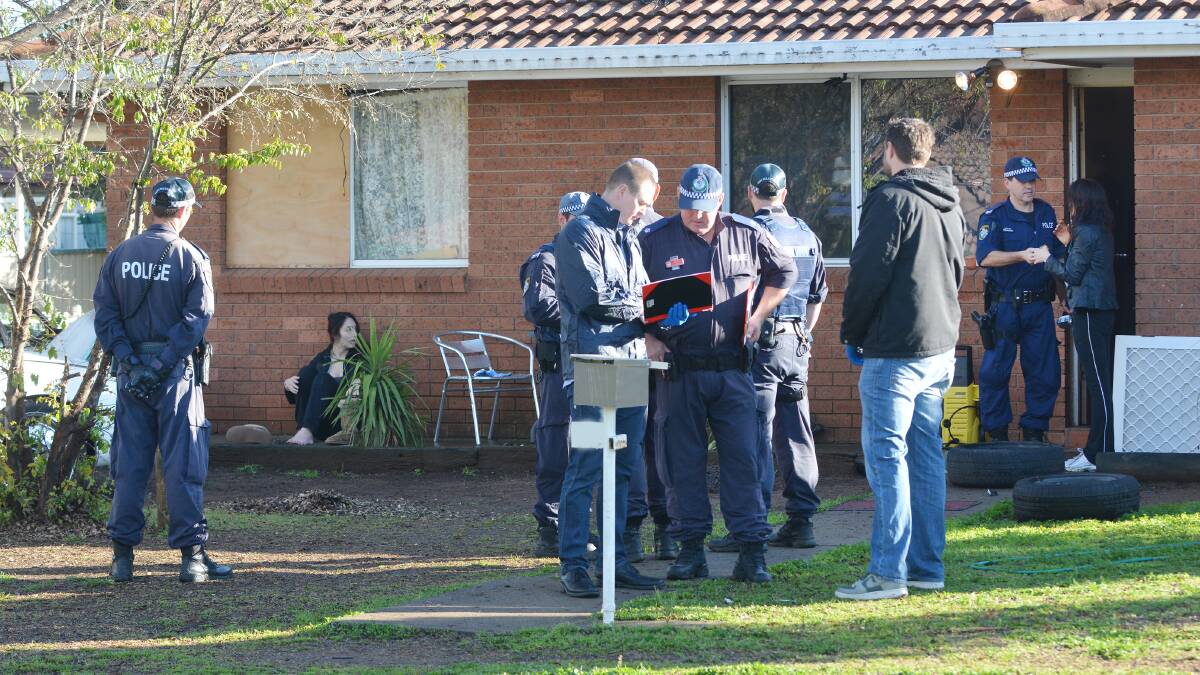 INVESTIGATIONS CONTINUE: Police at the scene of a home in Maxwell St, where weapons and drugs were discovered on Thursday morning.