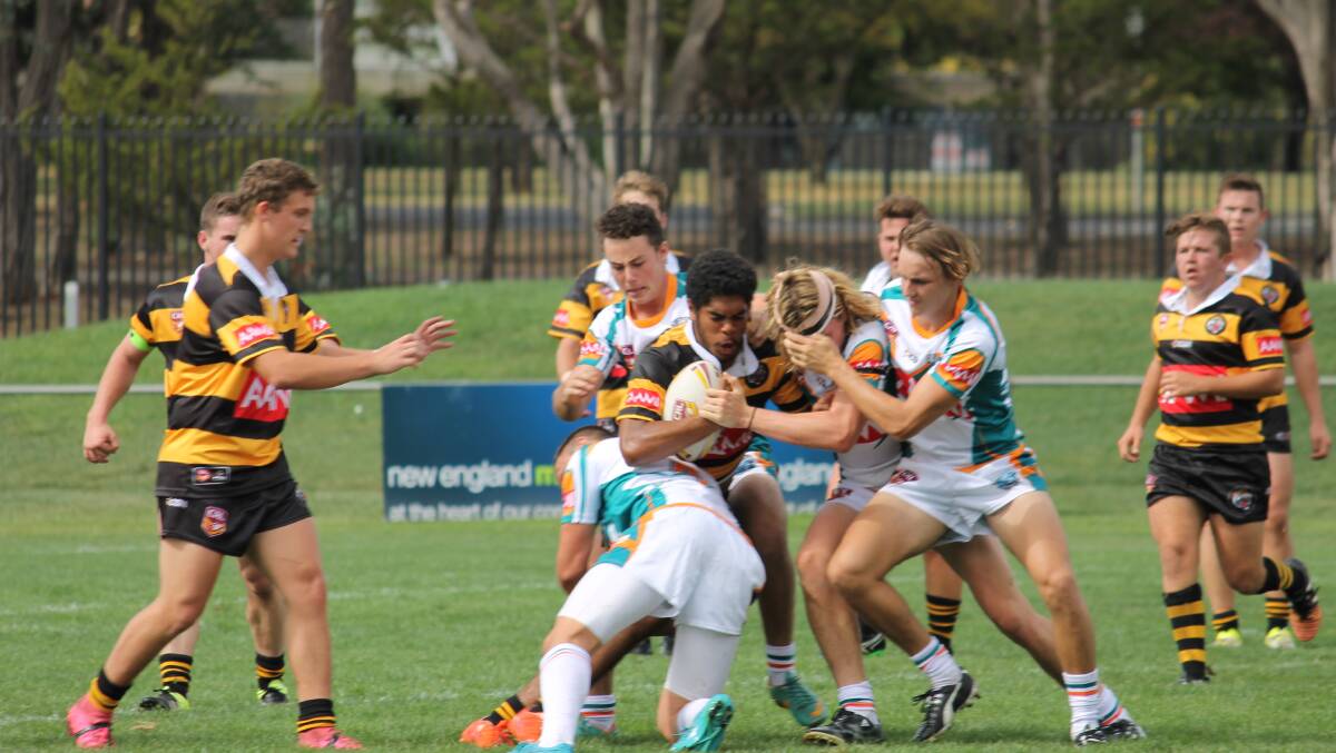 Elijah Rasiga hits the ball up for the GN Tigers in last Saturday’s win over East Coast Dolphins in Armidale. Teammates (from left) Lachlan Duwakin, James Fisk, Ryan Ingram and Lewis Hamilton (back right) look on. Rasiga will start on the wing for the Tigers tomorrow after excelling off the bench last week. Photo: Scott Bone