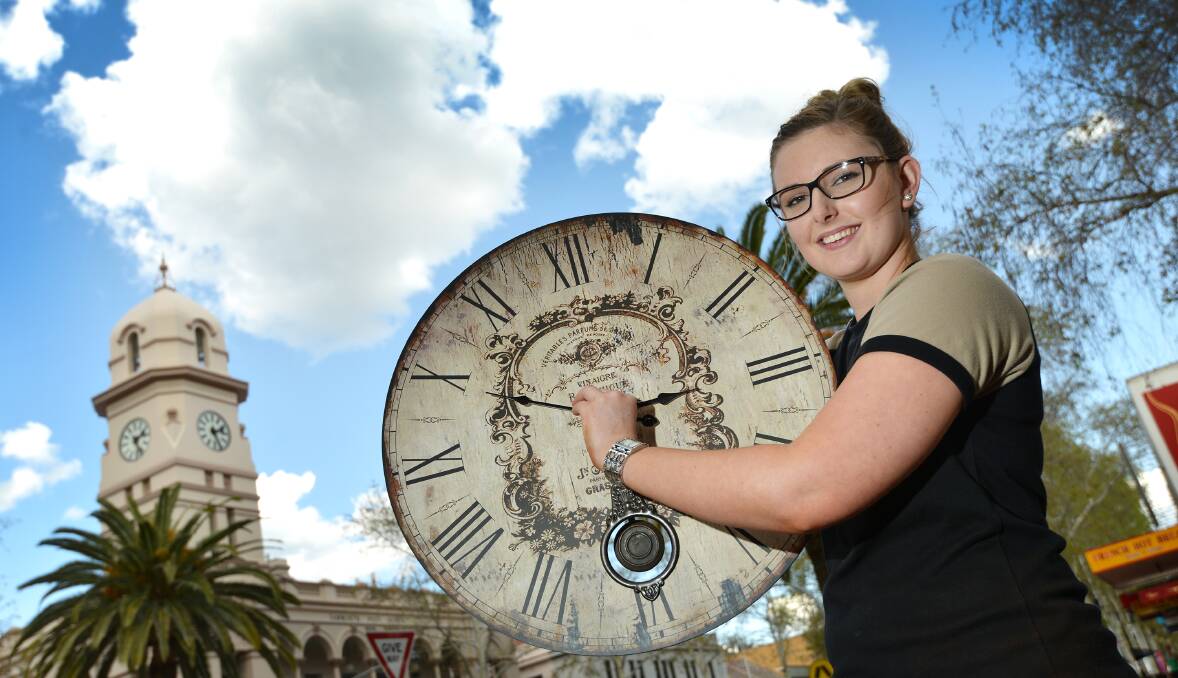 TIME ON: Jordyn Rolfe from Gloria Jean’s was getting ahead of herself yesterday, turning the clock forward an hour for the start of daylight saving. Photo Barry Smith 