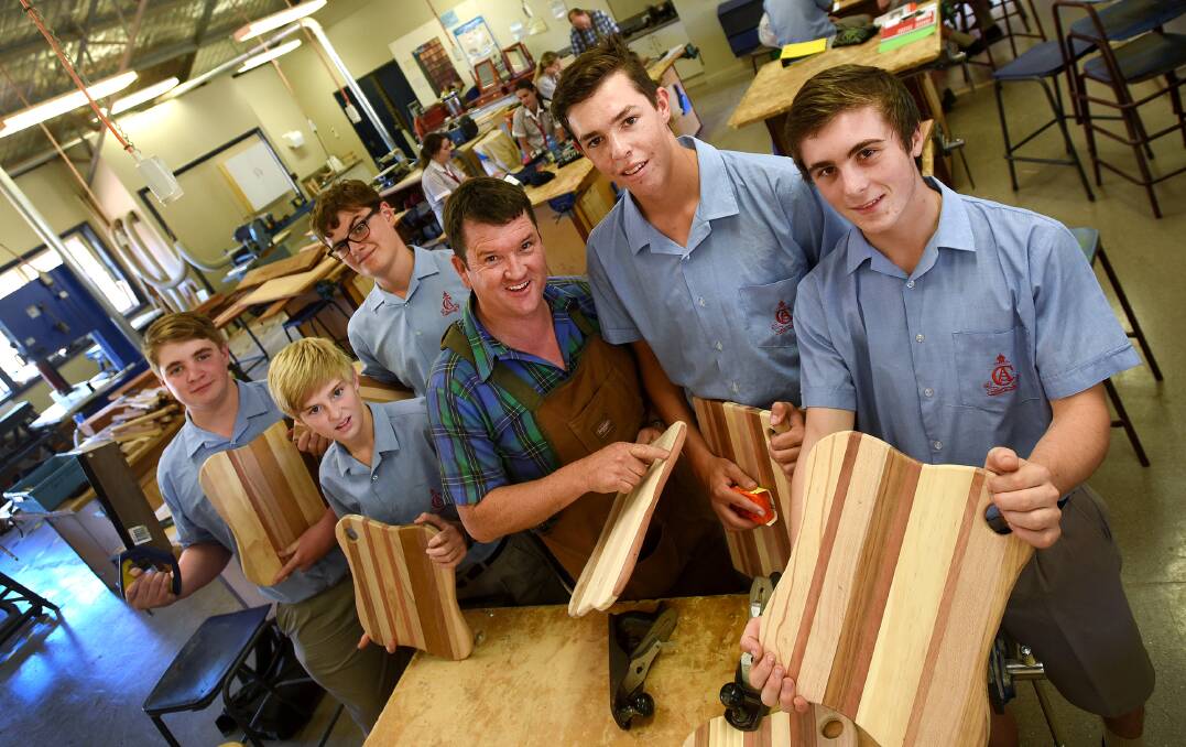 GETTING THE CHOP: Showing off their special chopping boards to be sold at next month’s Calrossy Cracker Night are, from left, Zac Hatton, Ethan Aspinall, James Trethewy, teacher Ian Scott, Angus Turner and Tom Harris. Photo: Gareth Gardner 190215GGF01