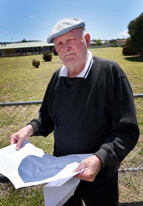FAIR GO: Just a few steps from his front yard, Mr Martin stands at the fence of Kootingal Bowling Club, which will be turned into a temporary camping ground throughout the year. Photo: Geoff O’Neill 011015GOC03