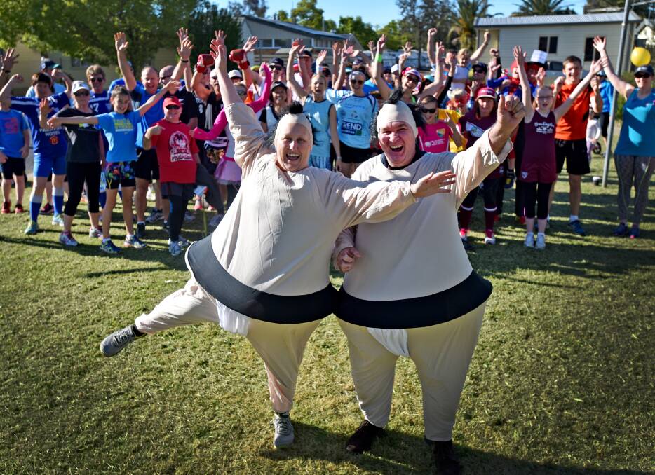 FUN RUNNING: Heather and Kevin Hunter celebrate the first birthday of the Tamworth Parkrun in sumo suits. Photo: Geoff O’Neill 260915GOA01