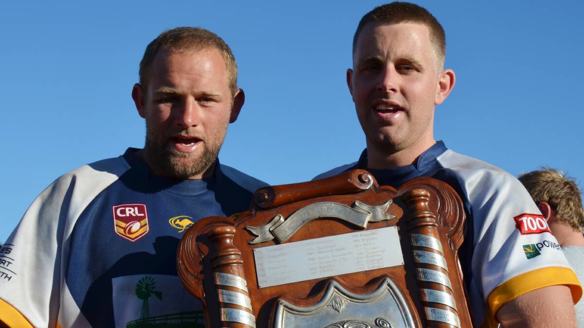 The Wilson brothers, Todd (left) and Matt with the second 
division premiership shield.