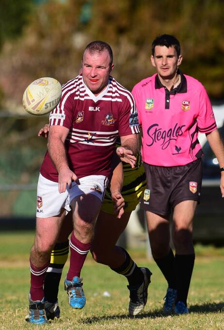 Phil Beaton sets the Lions on the attack on Sunday as 
referee Michael Lace looks on.  Photo: Gareth Gardner  190715GGD15