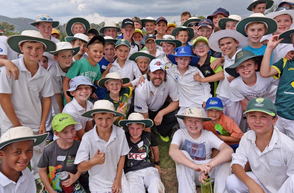 Nathan Bracken (centre) is swamped by some young cricket fans at the Shaun Brown coaching clinic yesterday. Photo: Geoff O’Neill 250116GOE01