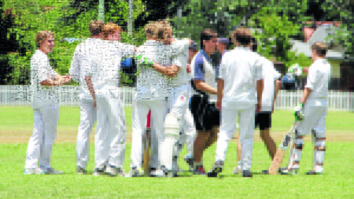 Watched by captain Ben Moffatt (far left) and Jack Evans, Jack Radford hugs Dominic Pilon after his dramatic six off the last ball helped TAS to tie with Sydney's Shore School in the TAS Cricket Festival this week. Photo: Tim Hughes