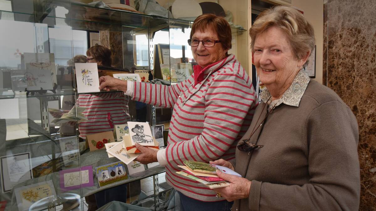 IN THEIR HANDS: Tamworth embroidery craftswomen Brenda Veall, left, and Dorothy Hawksworth have some special connections to the new commemorative postcard collection on show at Wests’ Diggers this month. Photo: Geoff O’Neill 010915GOB02
