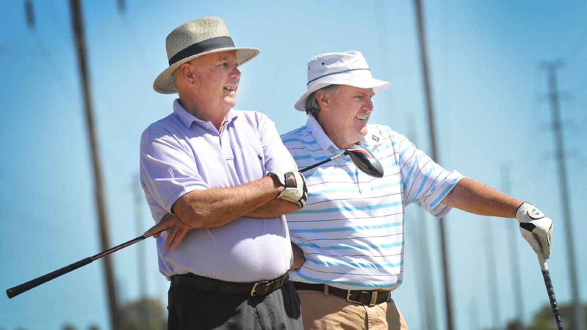 Lester Koch (left) and  Gary Norris survey their fairway drive at Carlo’s IGA Golf Day.  Photo: Barry Smith 110914GGA08