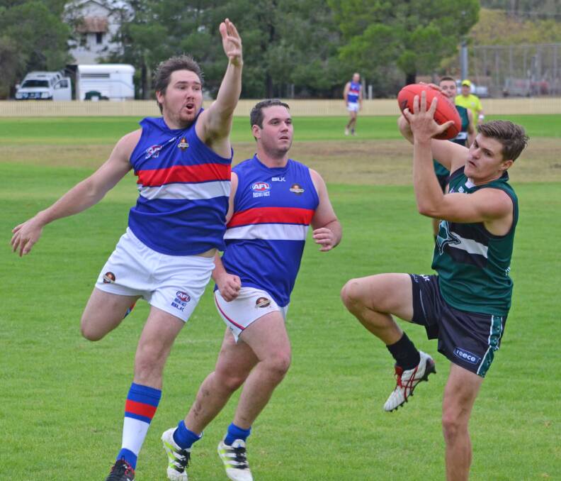 Nomads skipper Jed Ellis-Cluff latches on to a mark in front of the sticks with Gunnedah’s Danny Johnson (left) and Andy Mack arriving just too late. 
Photo: Chris Bath 010516CBA20