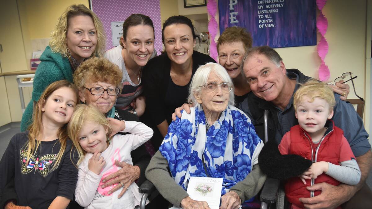 MARKING FAMILY MILESTONE: Audrey Cross (centre) celebrates with family members, in front: great-grandchildren Charlotte and Lily van Epen and Jack Cross-Felstead, back row: Belinda Cross, Rhonda Cross, Tina van Epen, Stacey Cross, Kerin Cross and Ken Cross. Photo: Geoff O'Neill 290615GOB01