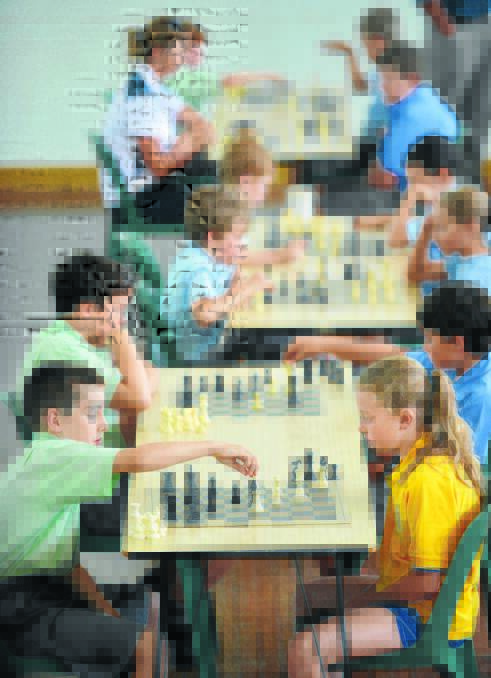 MY MOVE: Elih Griffiths from St Nicholas’s Tamworth and Emily Dent from St Joseph’s Quirindi do battle at the chess comp. Photos: Barry Smith 271115BSA19