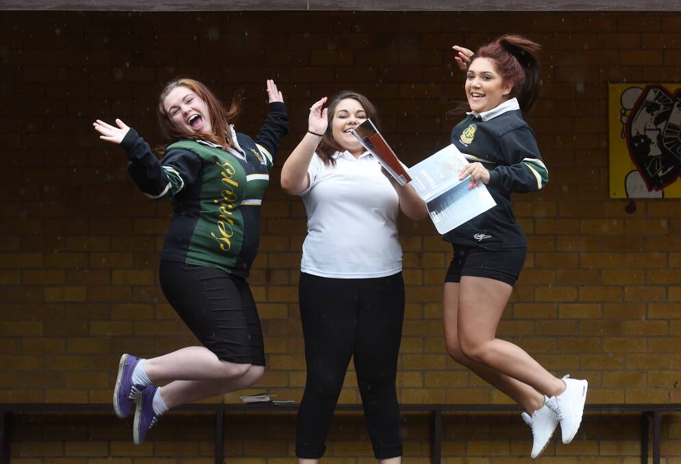 JUMPING FOR JOY: Peel High School students Kayla Crosby, Cassie Withers and Samantha Duncan celebrate completing the very last HSC exam, visual arts. Photo: Gareth Gardner 041115GGC003