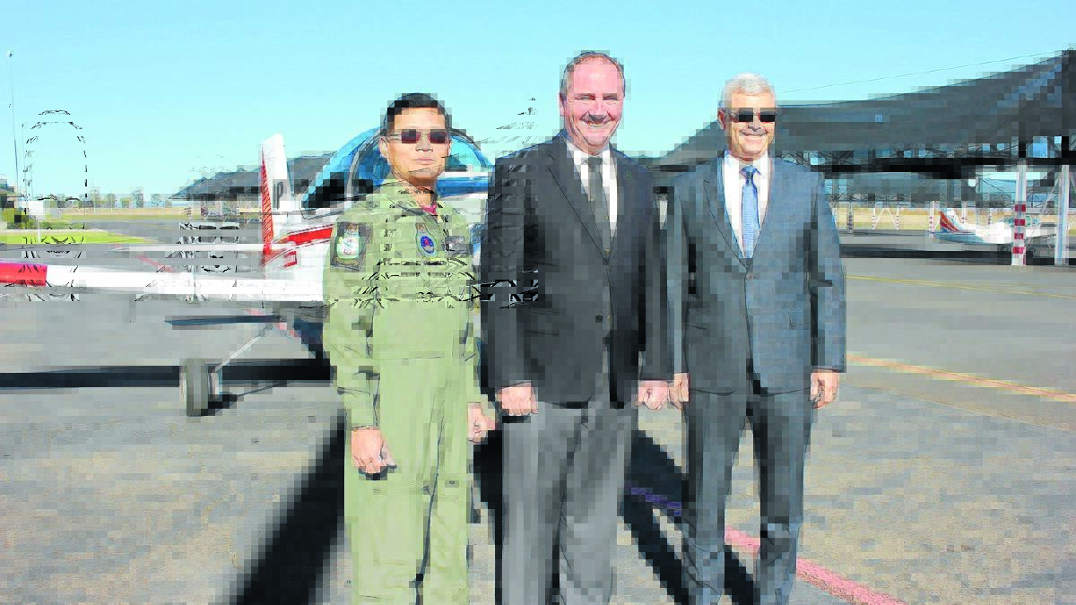 CONTRACT EXTENSION: Acting Commanding Officer of the RSAF AGC Major Aaron Ang, Member for New England Barnaby Joyce and BAE Director Aerospace Steve Drury.