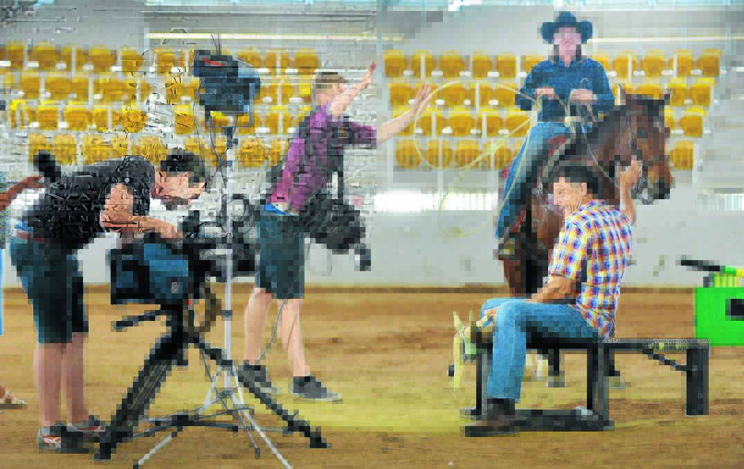 THE MAGIC OF TELEVISON: Sydney Weekender host Mike Whitney getting lassoed at AELEC by crewmen Chris Erdos (sound) and Geoff O’Rourke (cameraman) as Tamworth cowgirl Phillipa Leys watches on. Barry Smith 071015BSA11